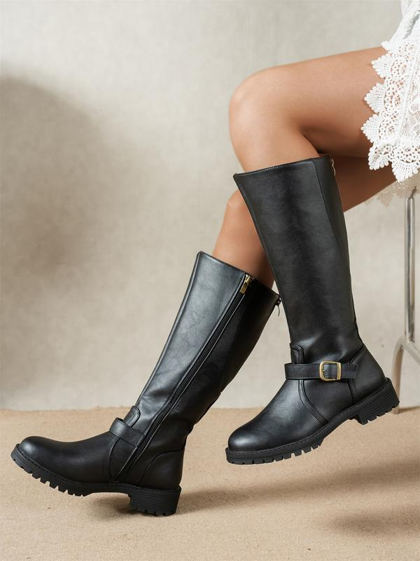 Side view of shaft upper with buckle strap, side zipper and lug sole, black
