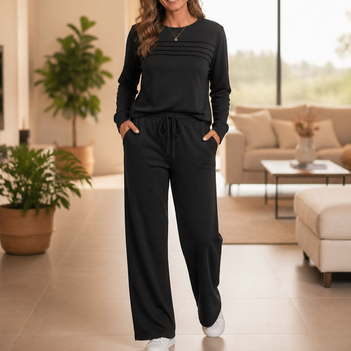 Front view of pleated bodice, side pockets and wide legs, black