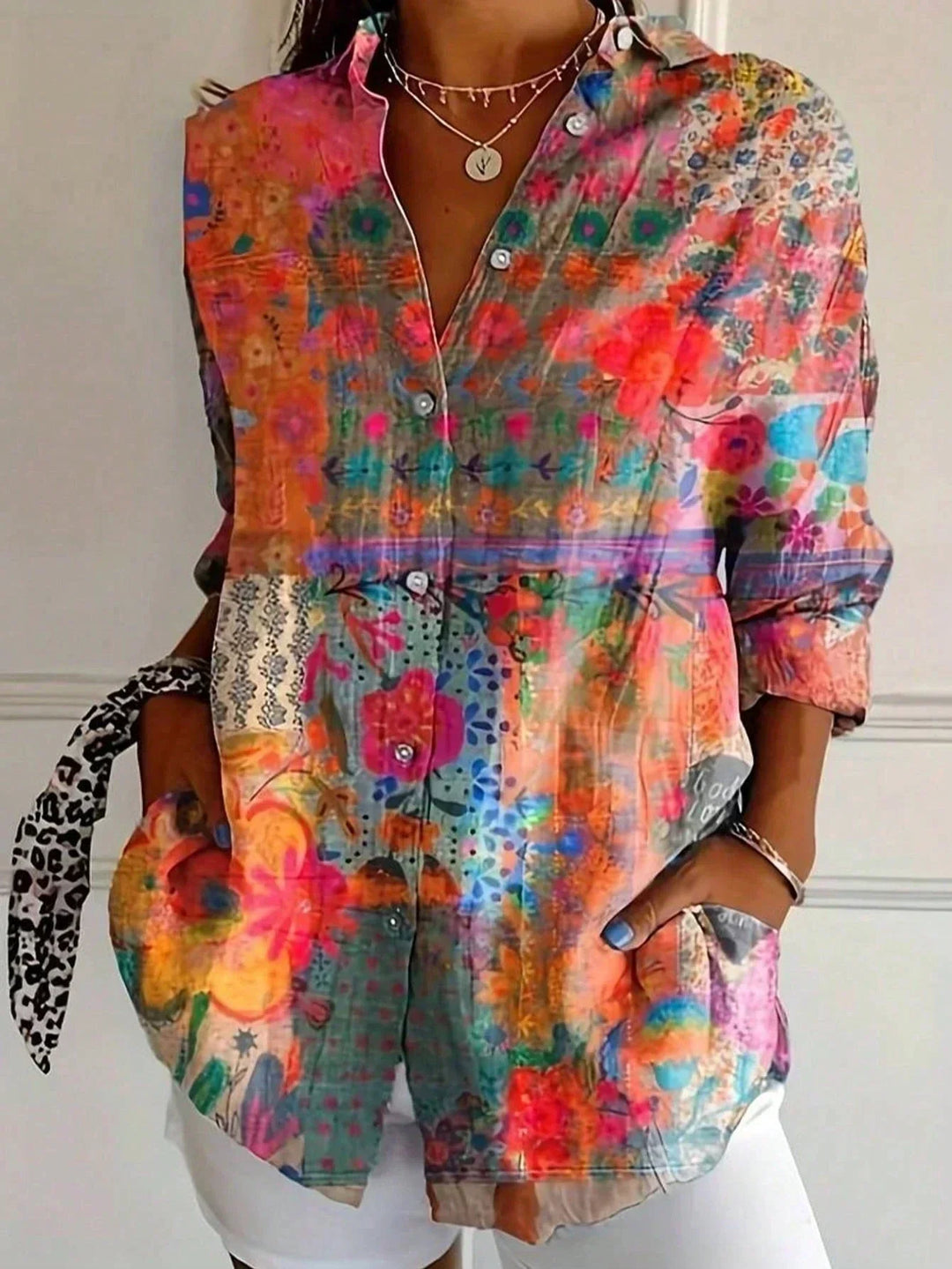 Front view showing v-neckline, button placket and long sleeves, orange
