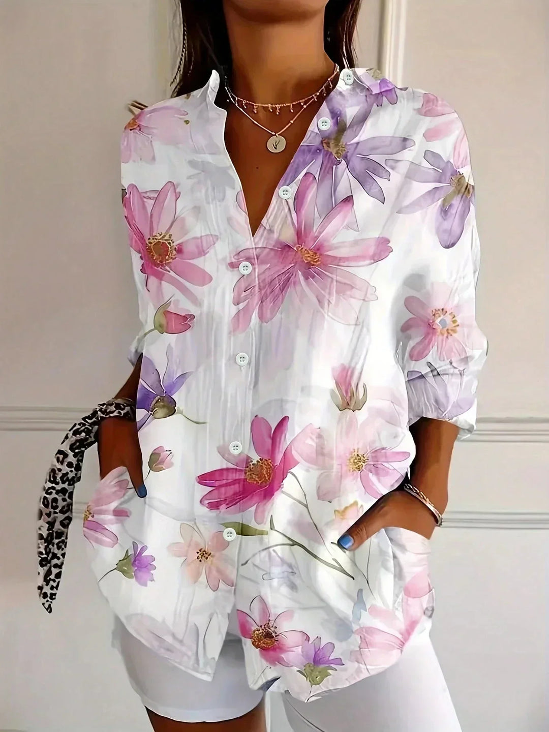 Front view showing v-neckline, button placket and side pockets, white
