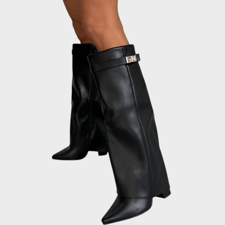 Side view of fold-over shaft, strap with twist-lock closure and pointed toe, black