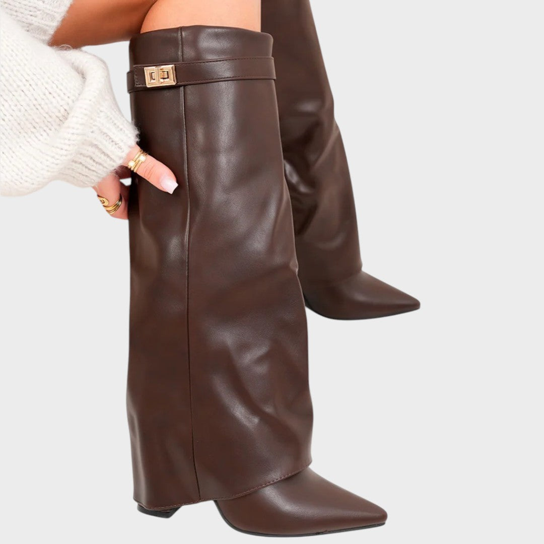 Front view of fold-over shaft, strap with twist-lock closure and pointed toe, brown