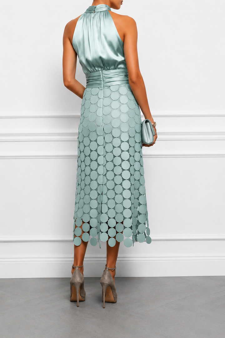 Back view showing open back, banded waist and cutout skirt