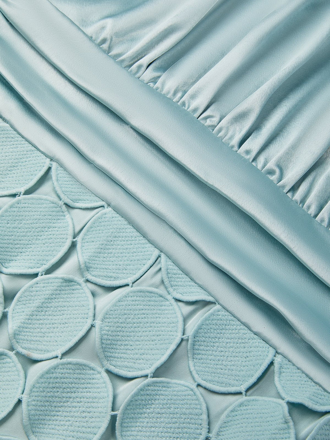 Detail view of the dress surface showing ruching and circle paillettes