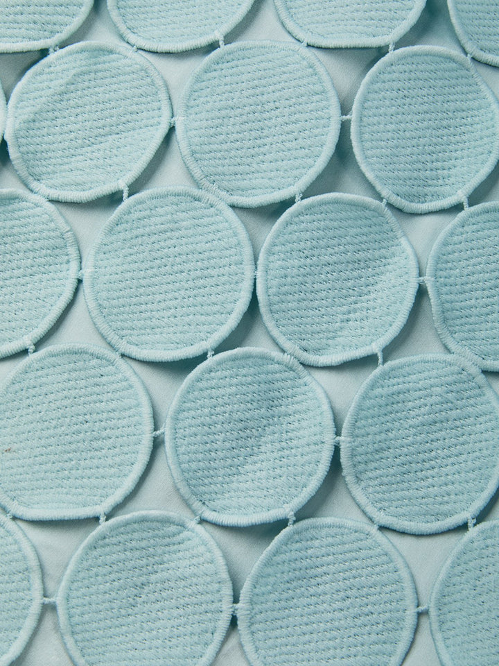 Detail view of the dress surface showing circle paillettes