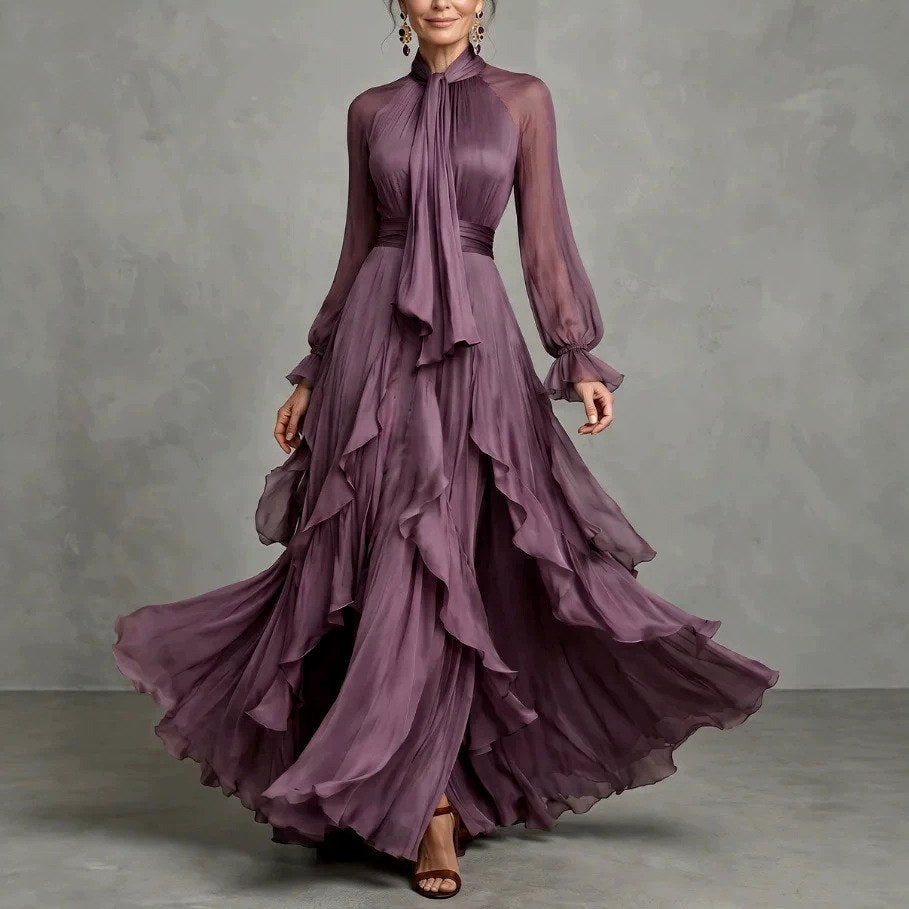 Front view of gathered high neckline with ties, long sleeves and ruffle layered skirt, purple