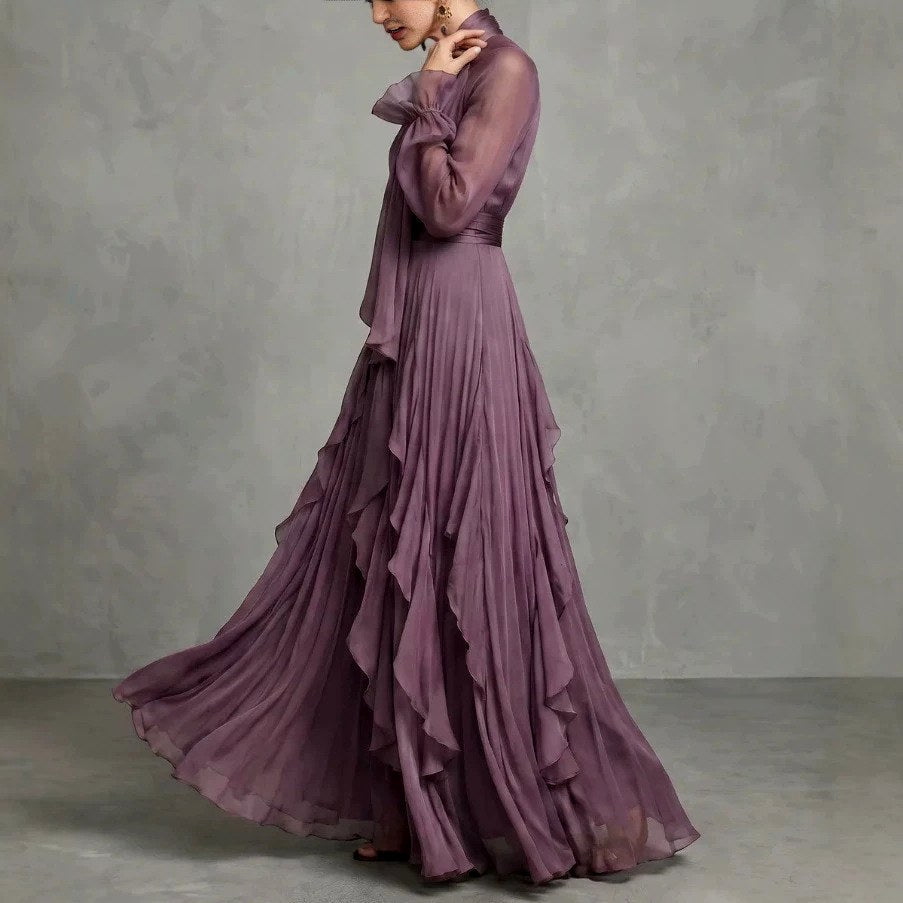 Side view of sheer long sleeves and ruffle layered skirt
