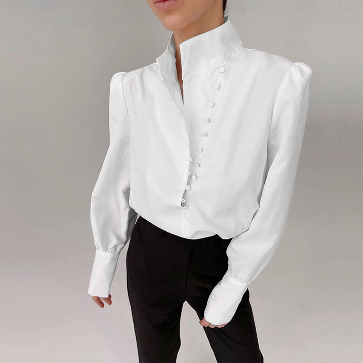 Front view showing the stand collar, button placket with covered buttons and banded cuffs, white