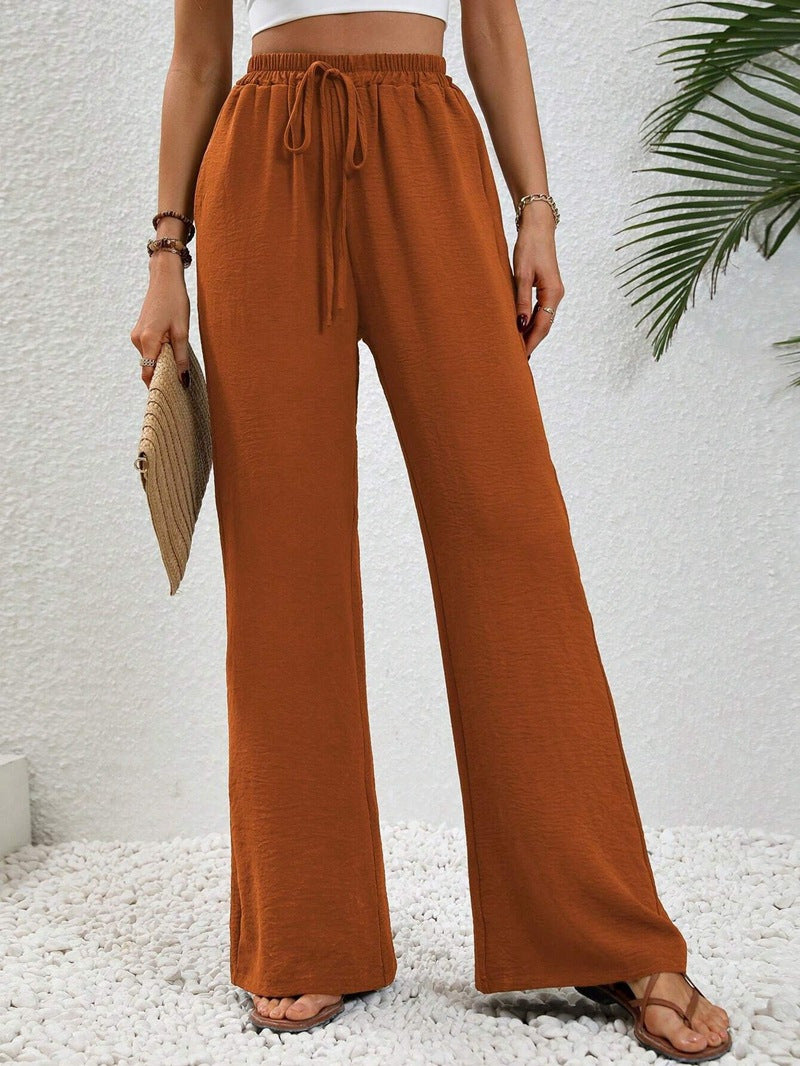 Front view of drawstring tie and wide legs, orange