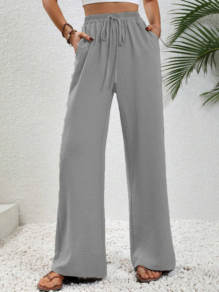 Front view of side pockets and gathered banded waist with drawstring tie, gray