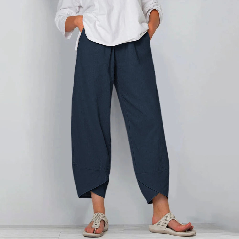 Front view of wide leg pants with side pockets and overlapping panel hem, navy blue