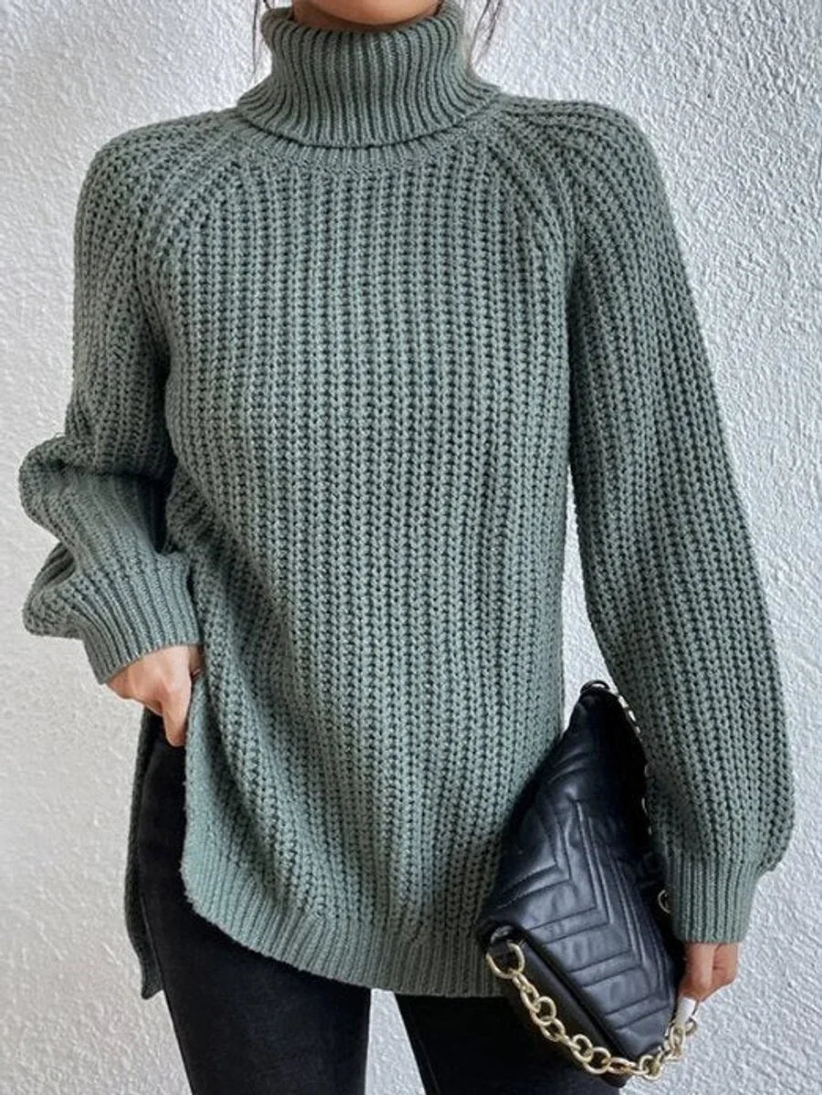 Front view of turtleneck sweater showing side slit, green
