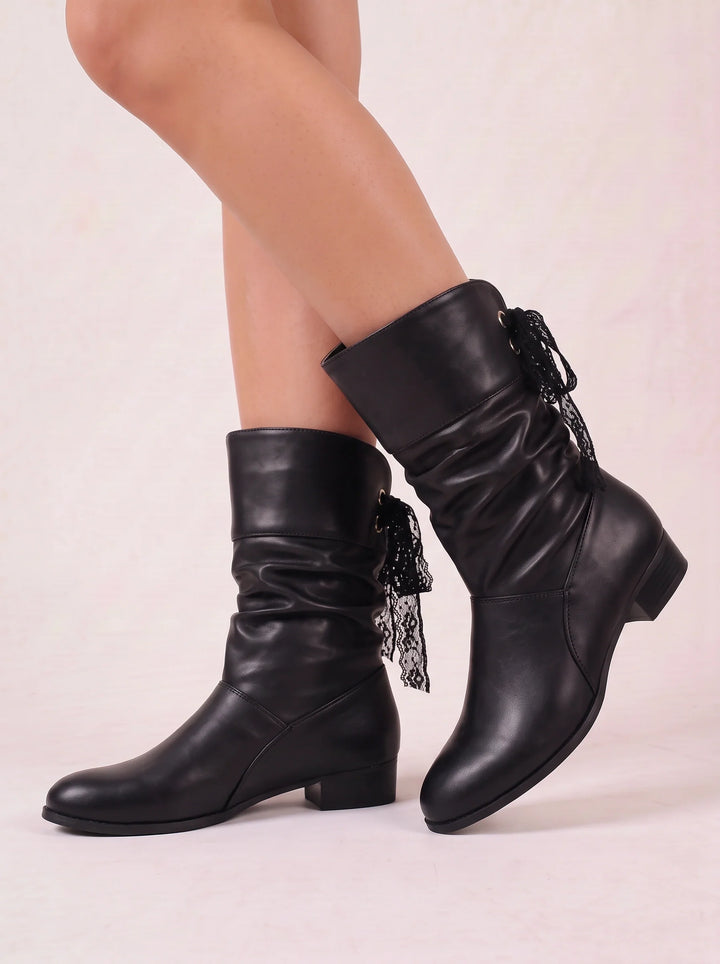 Side view of ruched shaft and bow tie back lacing, black