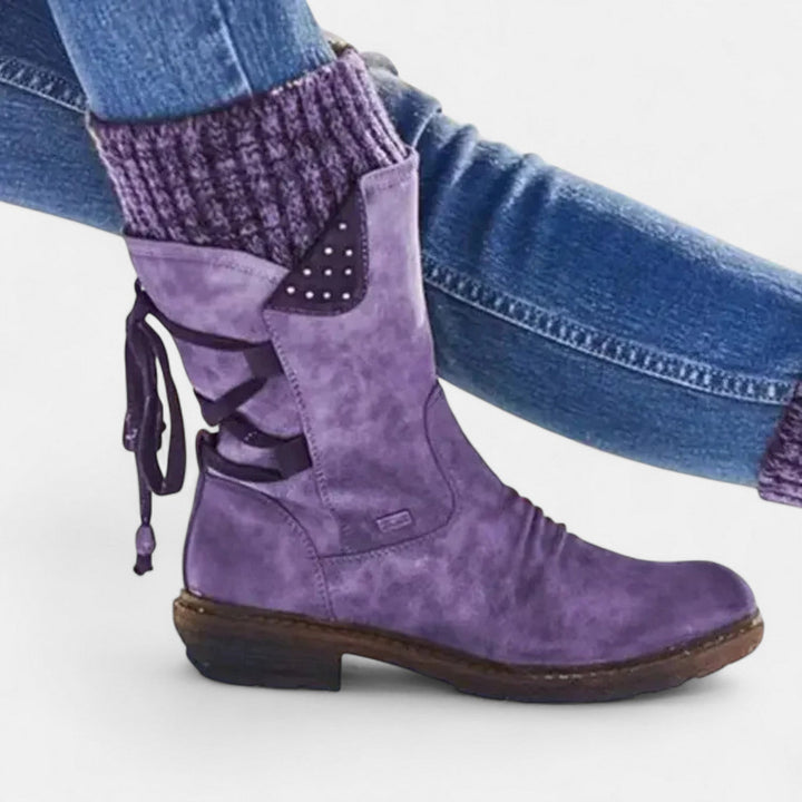 Side view showing ribbed cuff, lace-up detailing and block heel, purple