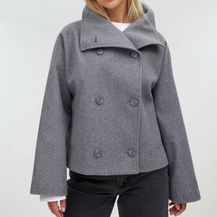 Front view with collared neckline, double-breasted buttons and long sleeves