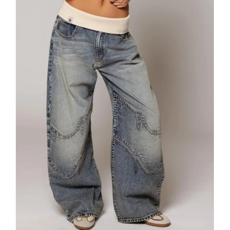 Front view of wide leg jeans with banded waist, front closure and curved stitched panels, light blue
