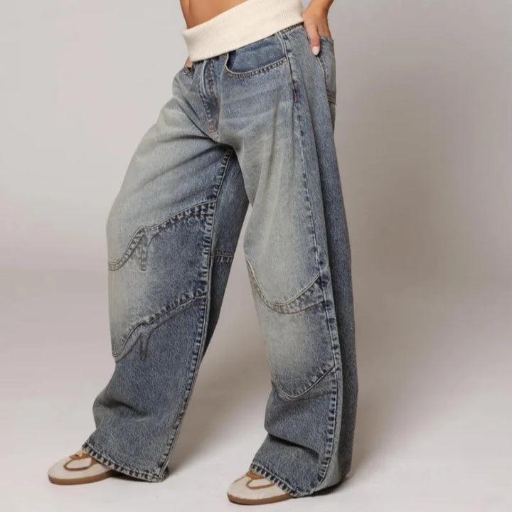 Side view of wide leg jeans with curved stitched panels