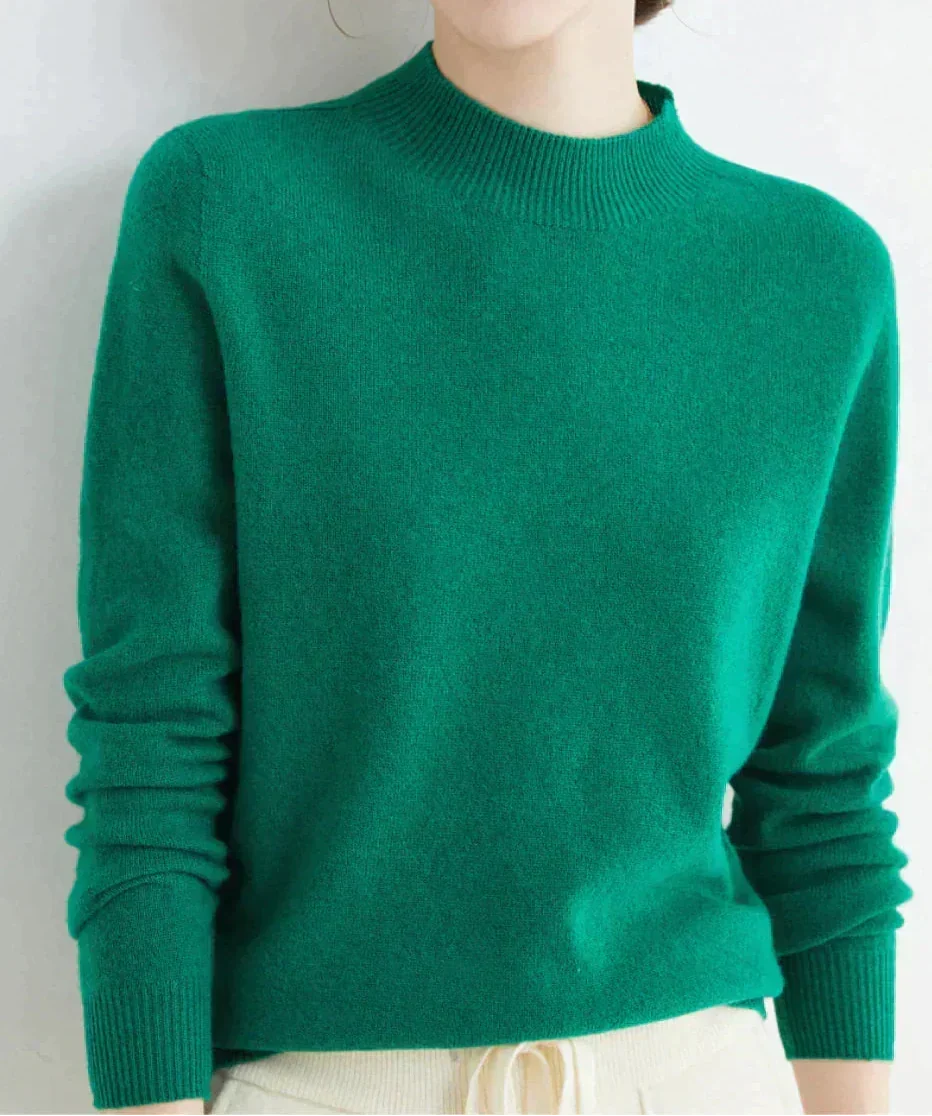 Front view of mock neckline and ribbed cuffs, dark green