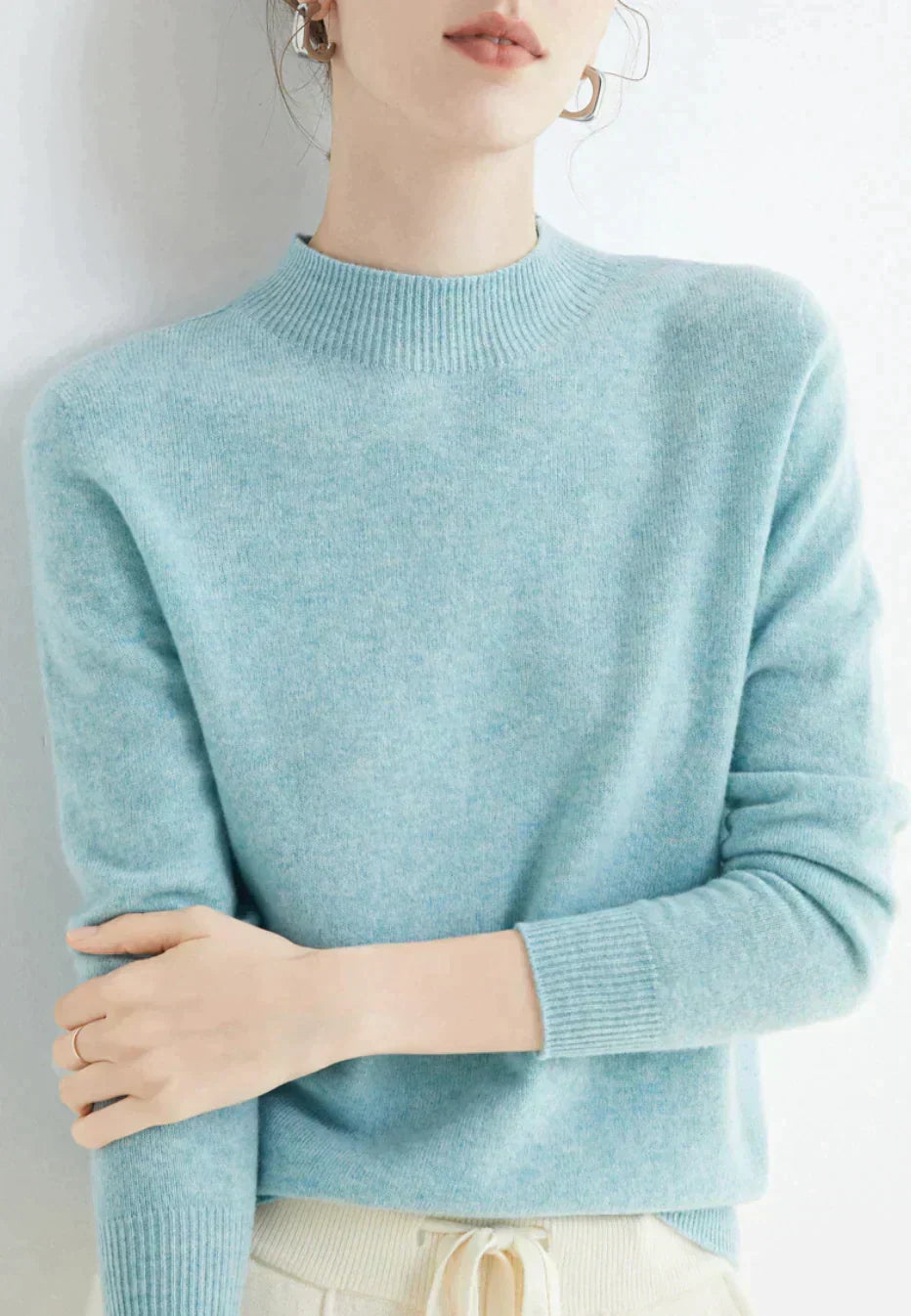 Front view of mock neckline and long sleeves, light blue