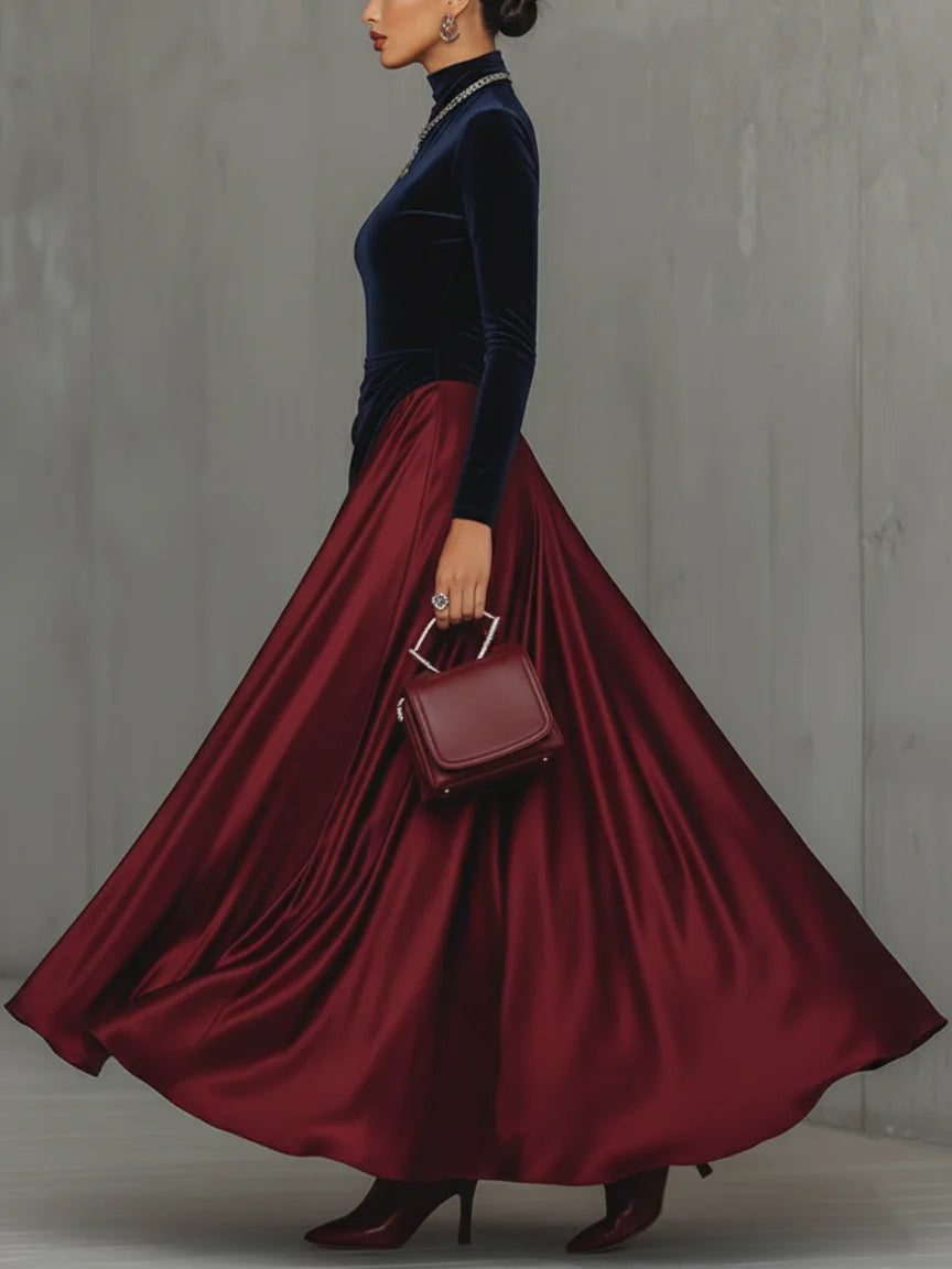 Side view of maxi dress with stand collar, long sleeves and floor-length skirt