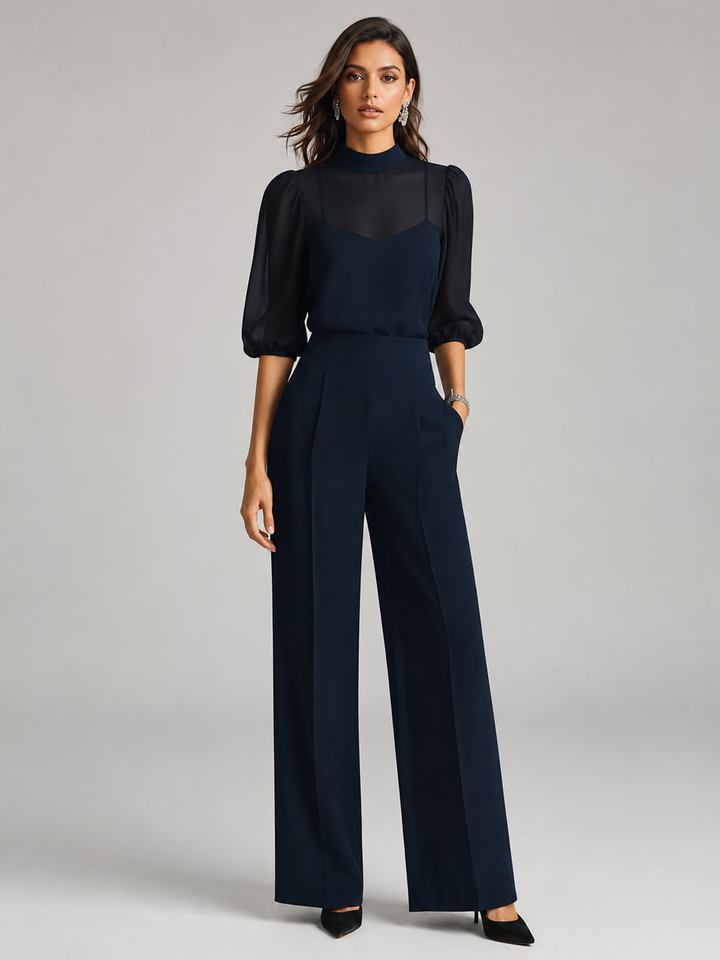 Front view showing mock neckline, puff sleeves and wide legs, navy