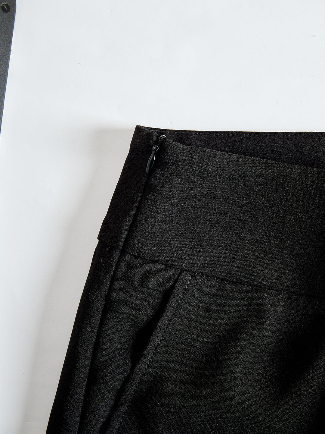 Detail view of banded waist with side zipper and side pocket