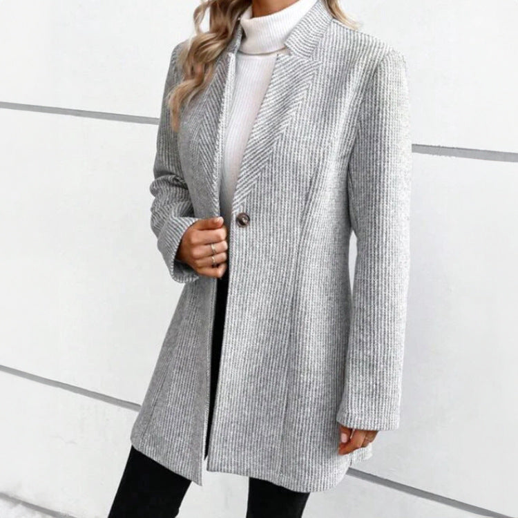 Side view showing notch lapels, long sleeves and above-knee hem
