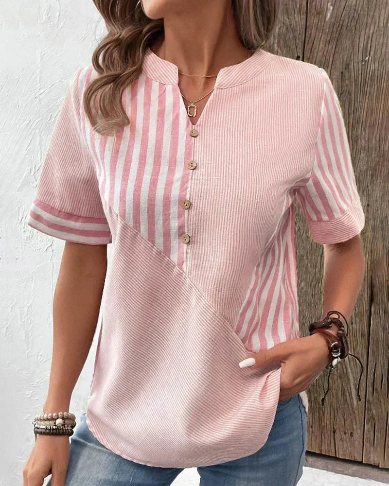 Front view showing notched neckline, button placket and short sleeves, pink