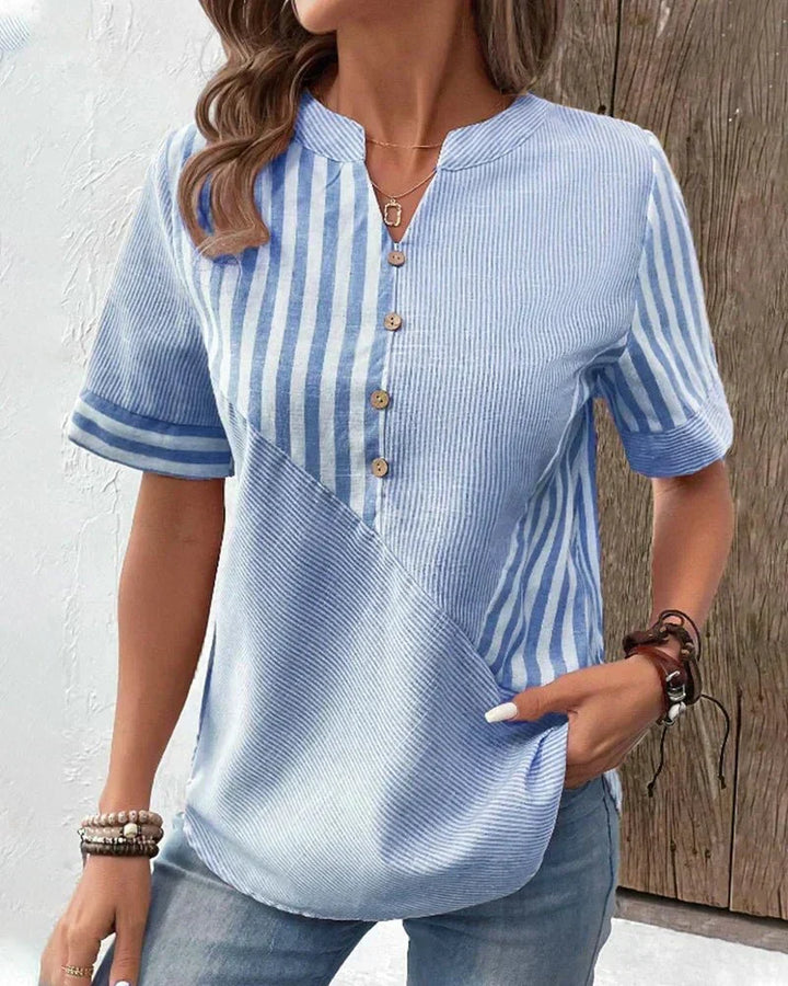 Front view showing notched neckline, button placket and short sleeves, blue