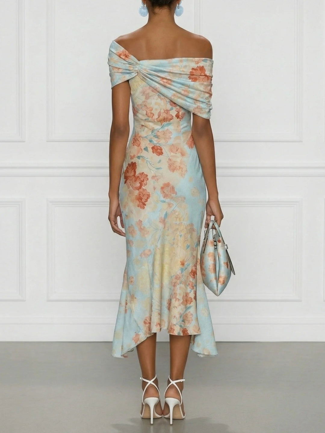 Back view of off-shoulder neckline, twisted back and ruffle hem