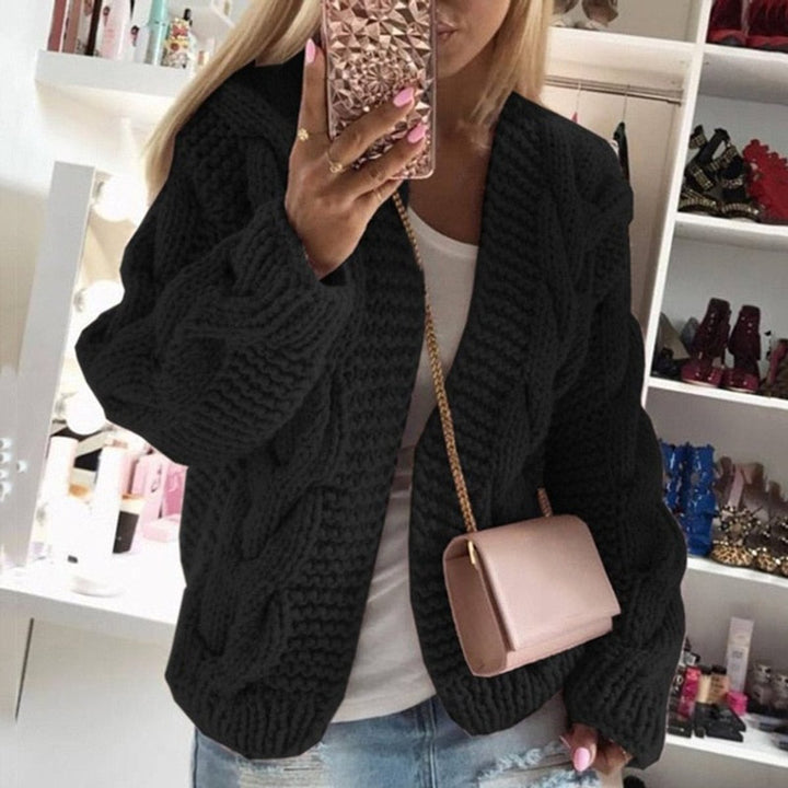 Front view of open front cardigan with long cable knit sleeves, black