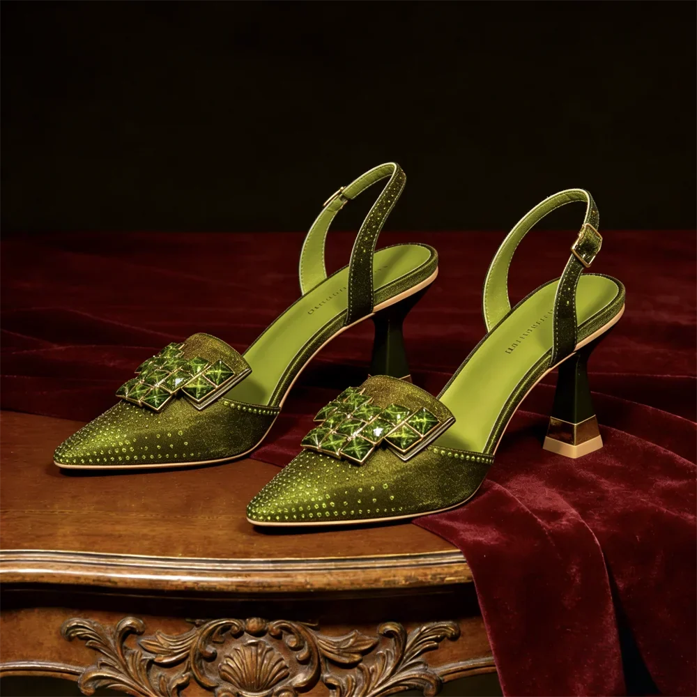 Side view of pointed toe heel with jeweled buckle plate and block heel