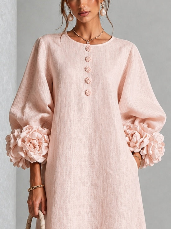 Detail view of round neckline, button placket and floral cuffs