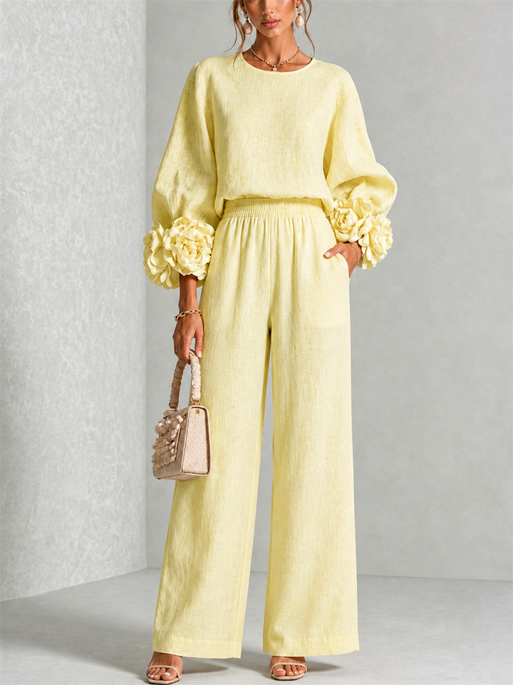 Front view of round neckline, floral cuffs, side pocket and wide legs, soft yellow