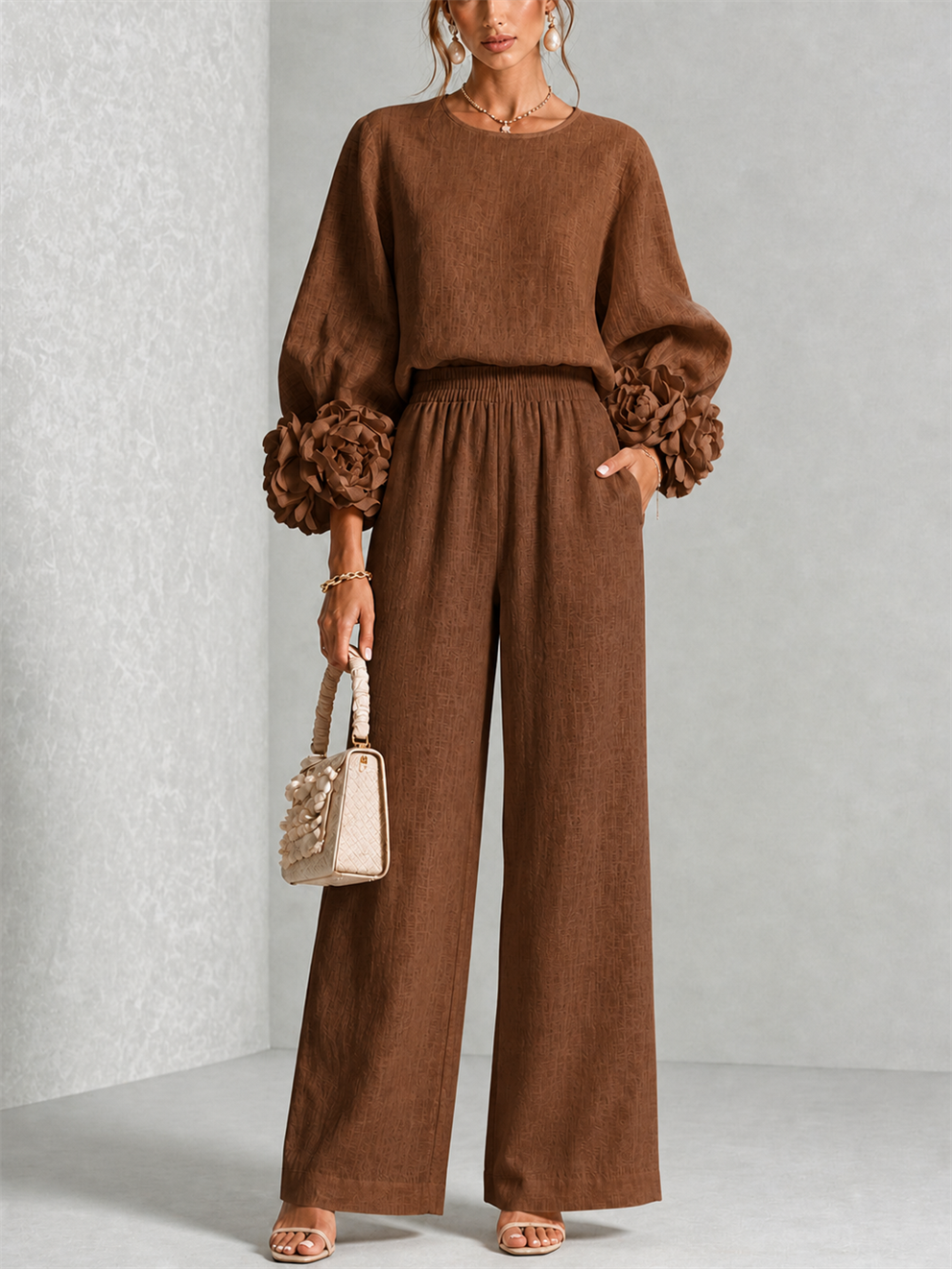Front view of round neckline, floral cuffs, side pocket and wide legs, brown