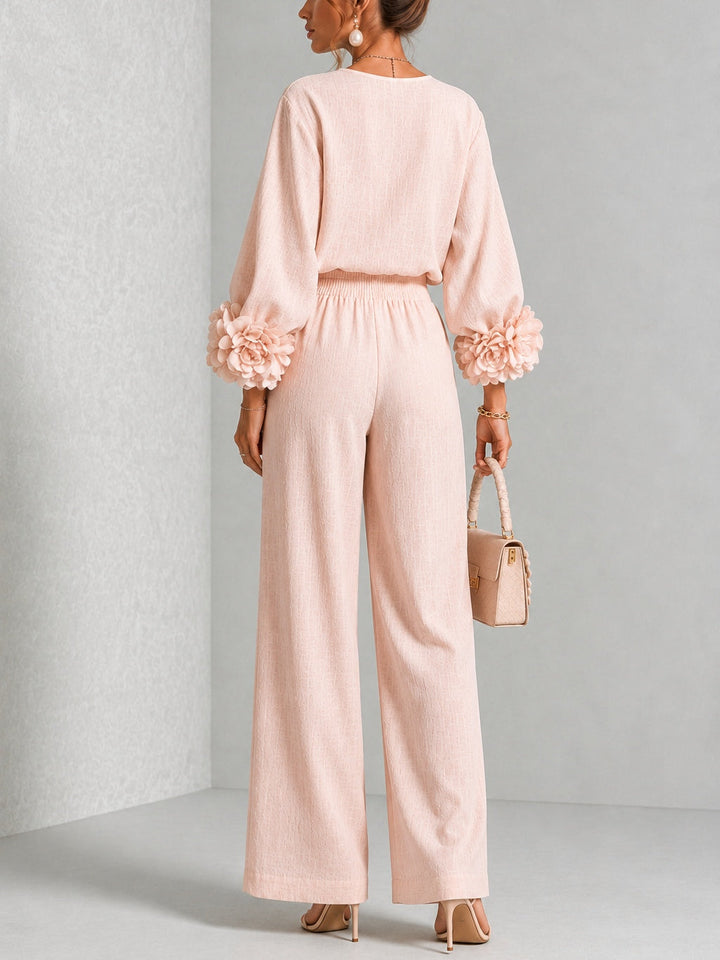 Back view of top with floral cuffs, banded waist and wide legs