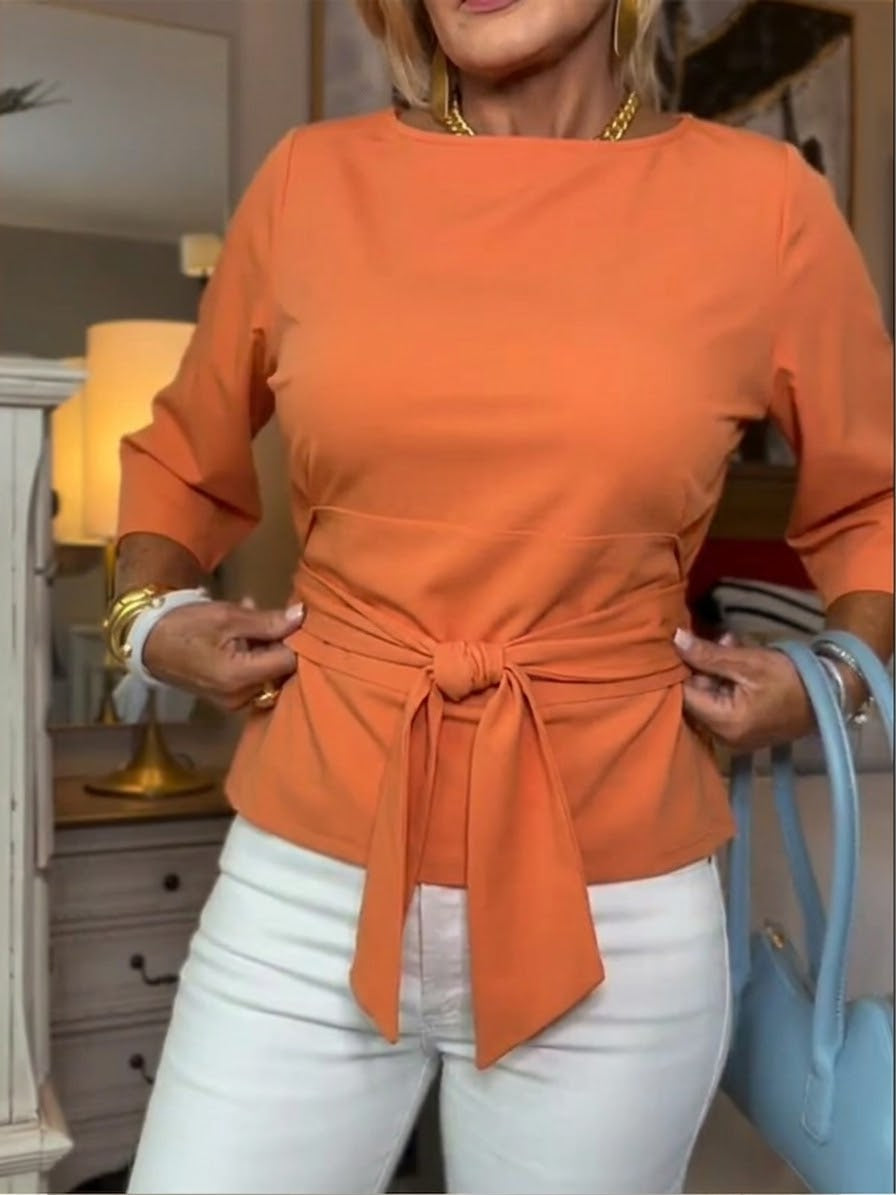 Front view of waist tie and bow front, orange