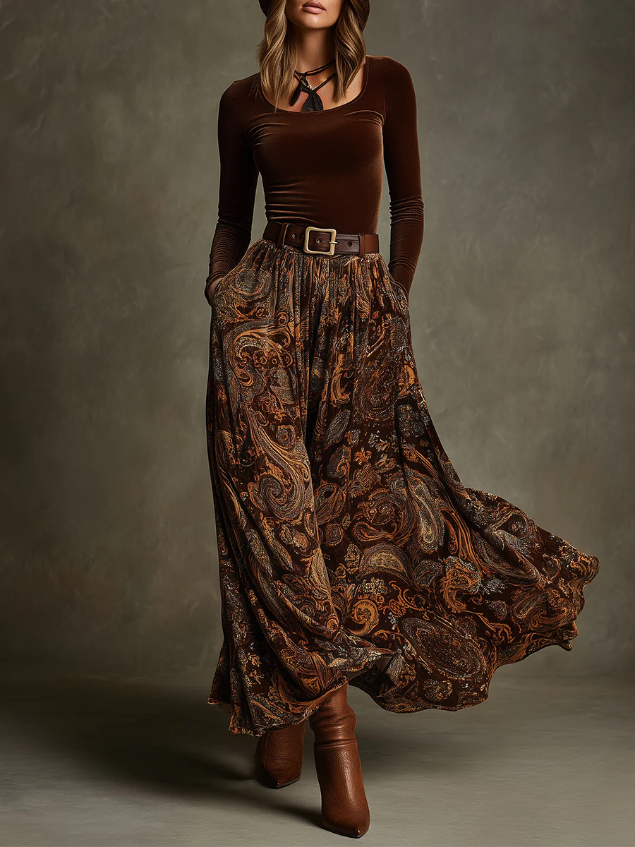 Front view of round neck long sleeve top with belted waist and floor-length paisley skirt, brown