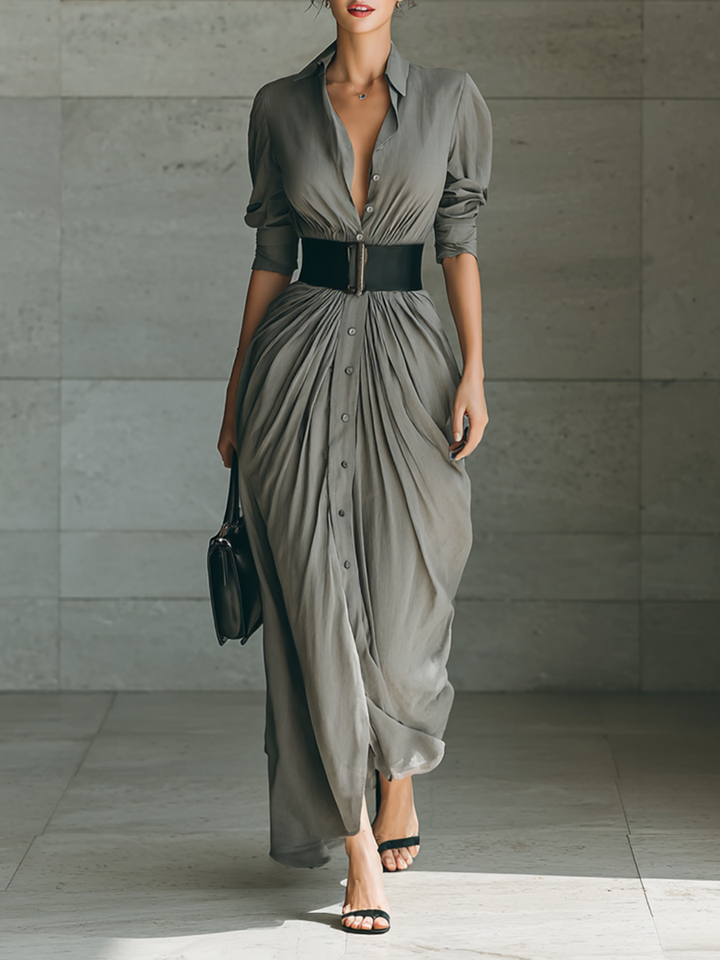 Front view showing shirt collar, button placket, long sleeves, banded waist and pleated skirt, gray
