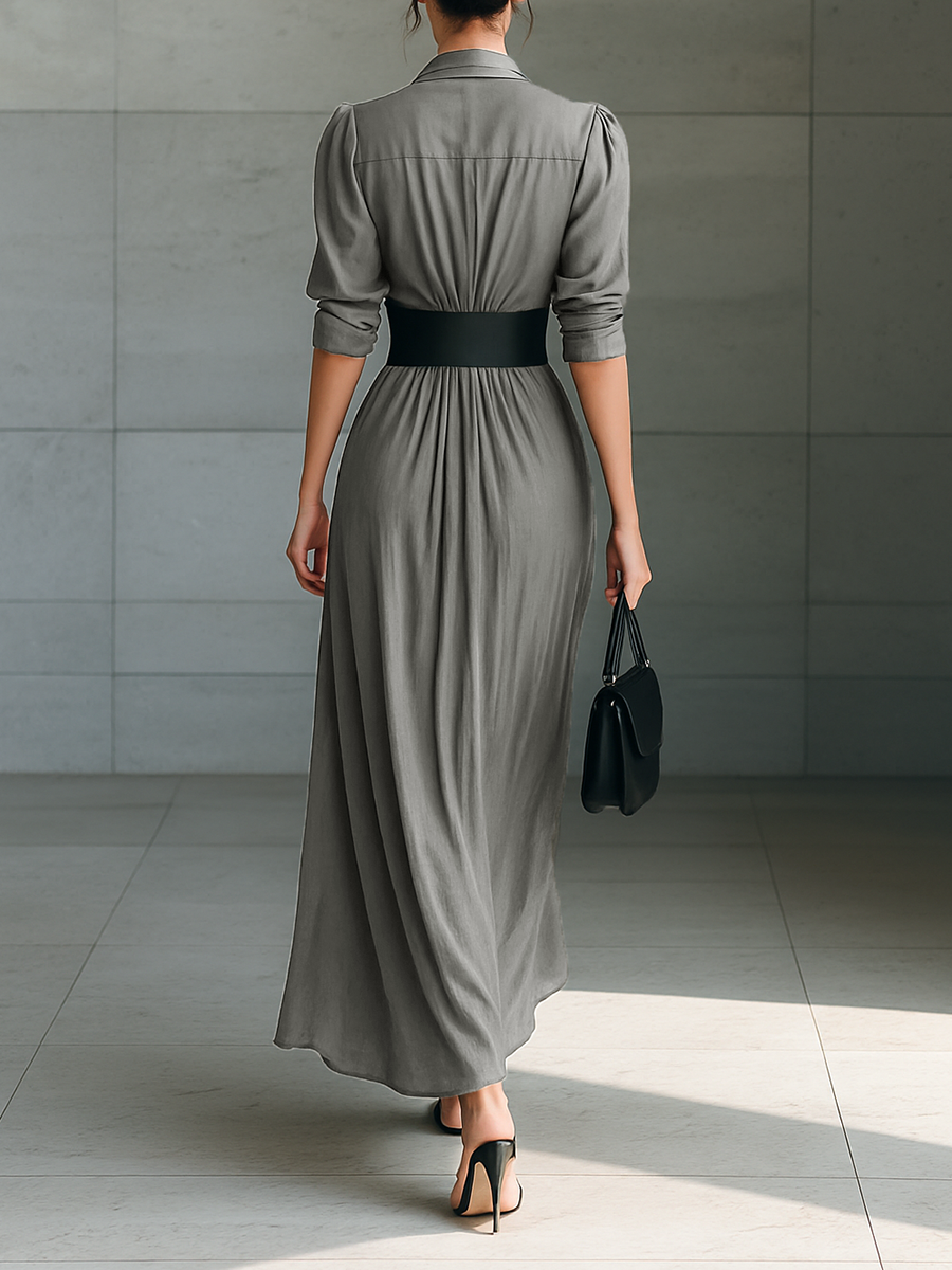 Back view showing collar, long sleeves, banded waist and pleated skirt