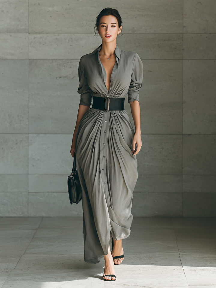 Front view showing shirt collar, button placket, long sleeves, banded waist and pleated skirt