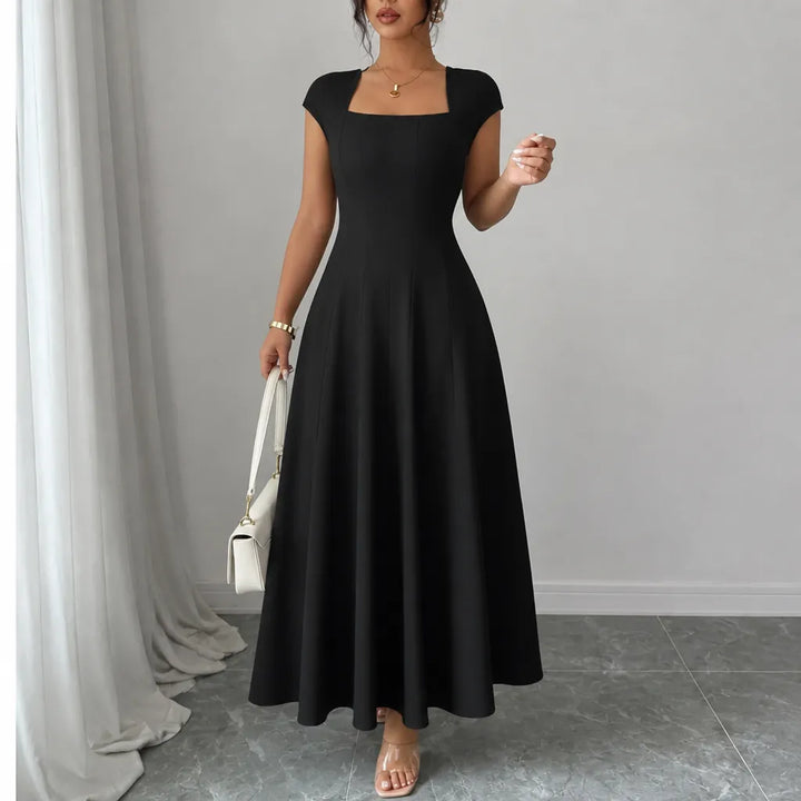 Front view showing square neckline, cap sleeves and skirt, black