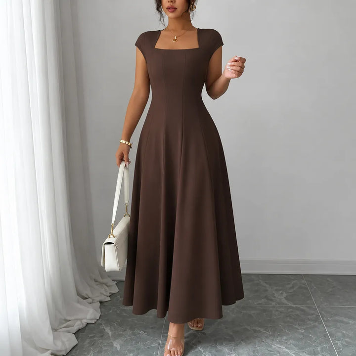 Front view showing square neckline, cap sleeves and skirt, chocolate brown