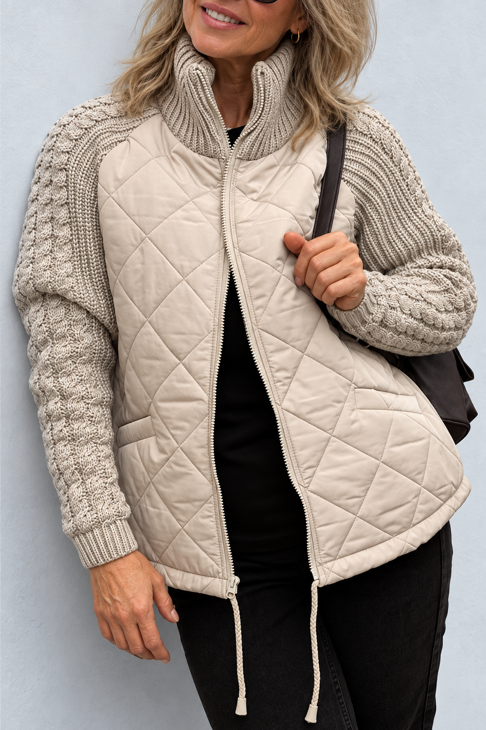 Front view of quilted jacket with stand collar, cable sleeves, front zipper and drawstring hem, khaki
