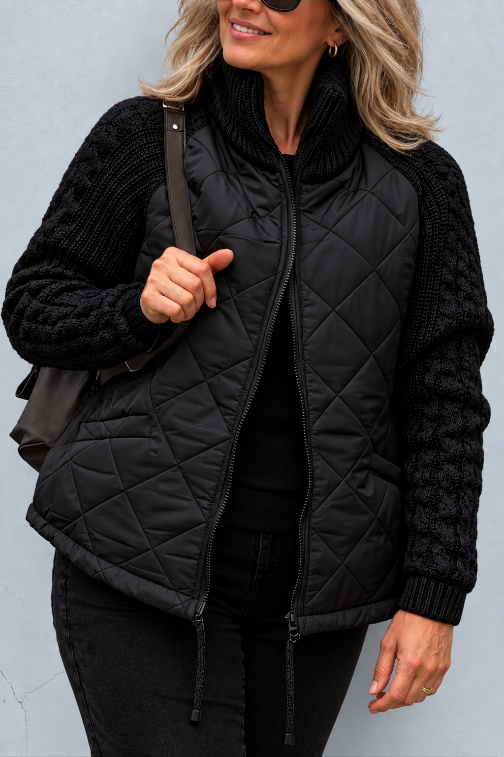Front view with stand collar, cable sleeves, quilted body and front zipper with toggles, black