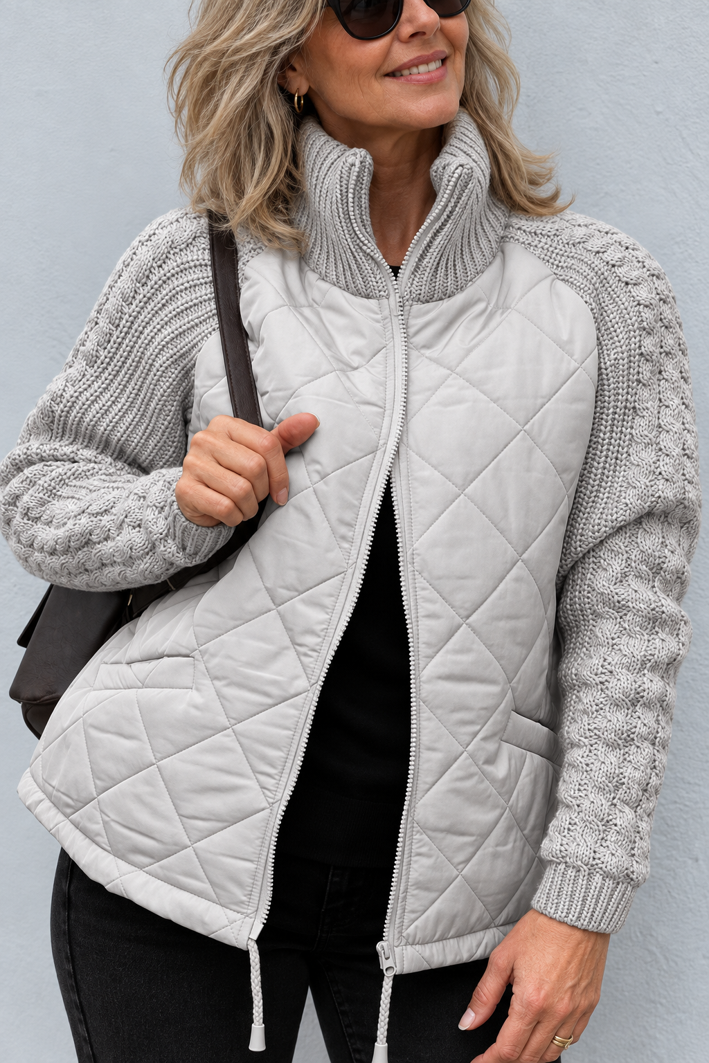 Front view with stand collar, cable sleeves, quilted body, side pocket and drawstring hem, gray