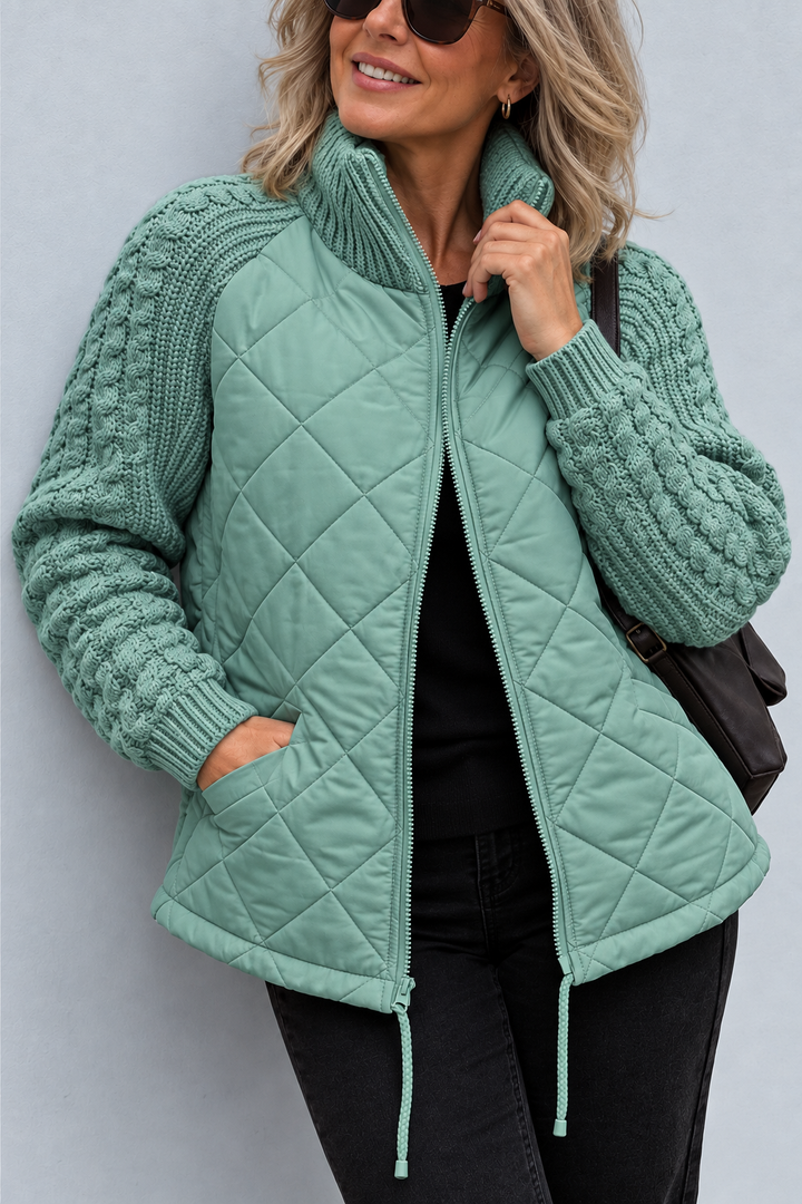 Front view with stand collar, cable sleeves and quilted body with side pocket, aqua sage