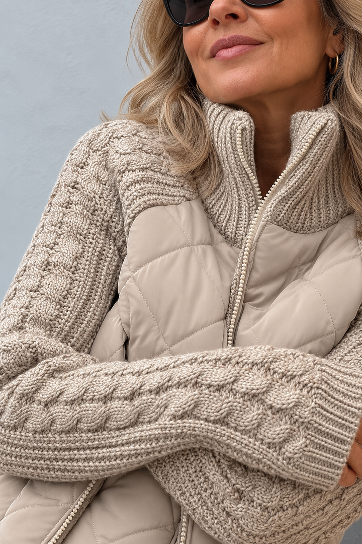 Detail view of stand collar and cable-pattern sleeves with banded cuffs