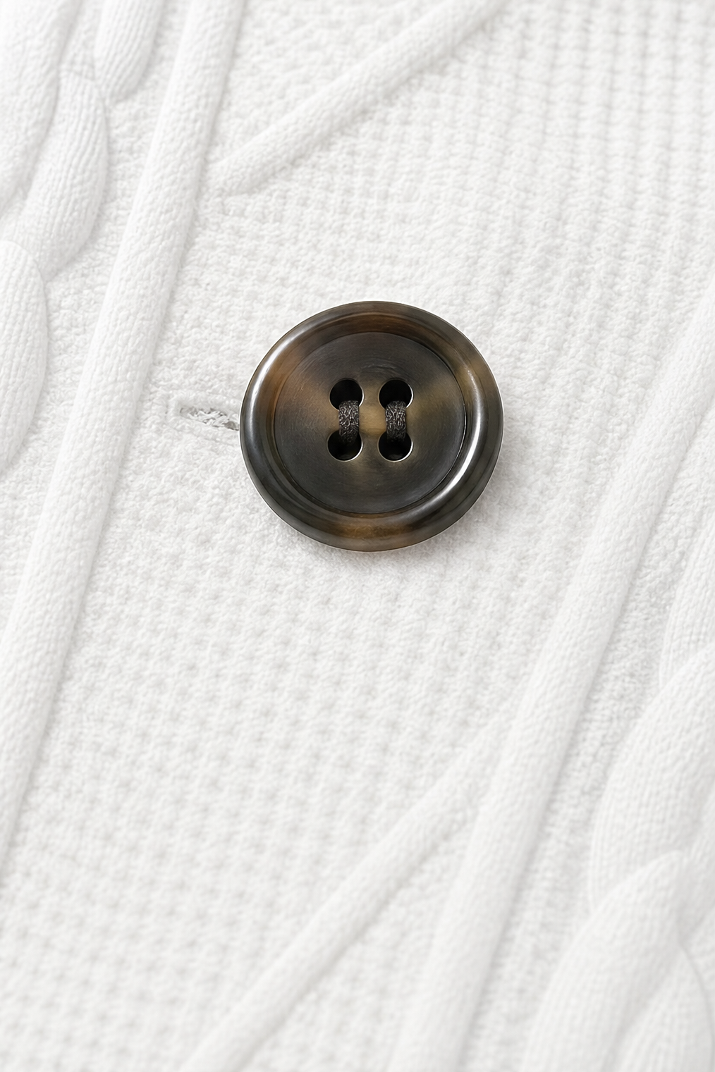 Detail view of button and buttonhole on textured panel