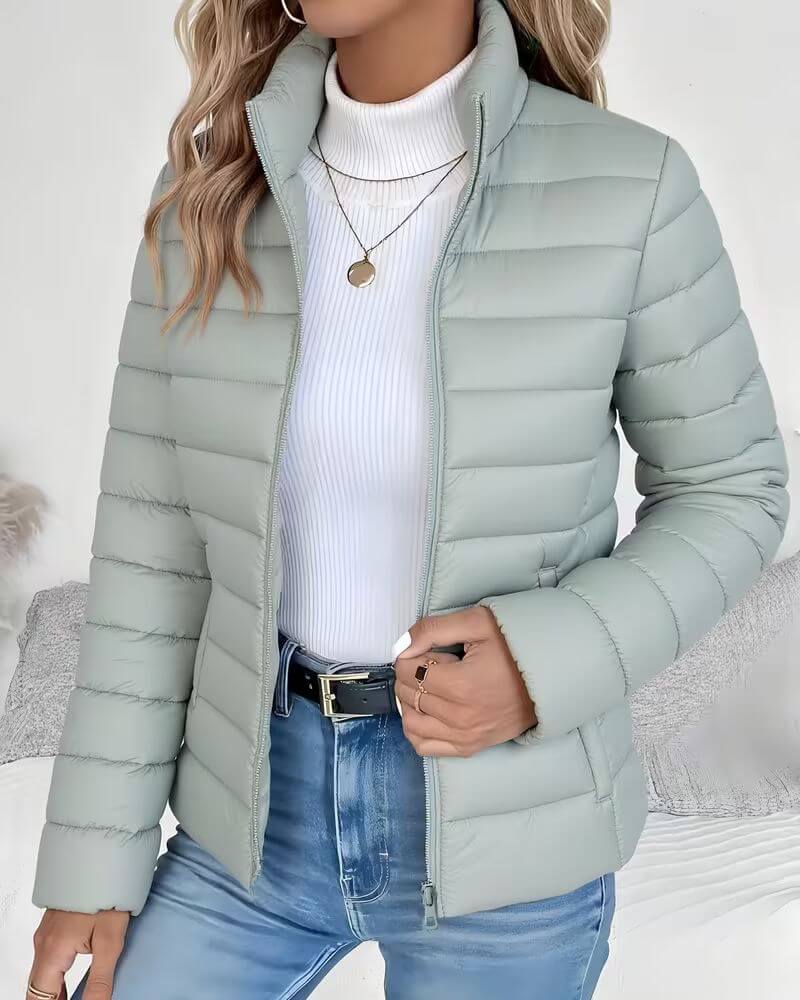 Front view showing stand collar, full zipper closure and side pockets, green